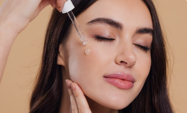 Best Morning Skincare Routine for Beginners: A Simple Step-by-Step Guide 3 Serum bottle and applying serum to the face, an optional step in a morning skincare routine for beginners