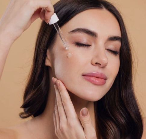Simple Night Skincare Routine for Glowing Skin: A Step-by-Step Guide 4 Applying a few drops of serum to the face, an optional step in a night skincare routine
