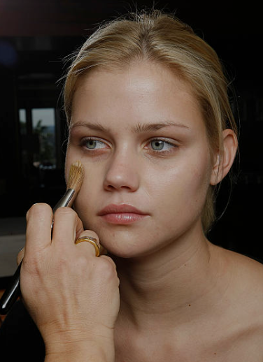 Blending foundation in thin layers for a smooth finish to make makeup last longer